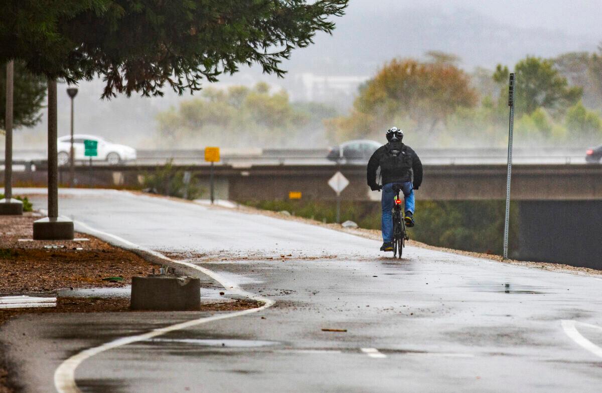 A man rides a bicycle along the San Diego Creek in Irvine, Calif., on Dec. 14, 2021. (John Fredricks/The Epoch Times)