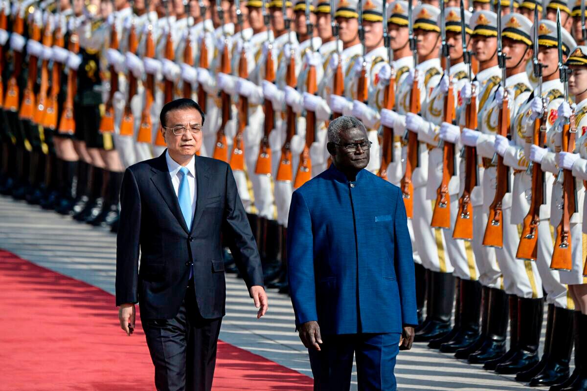 Solomon Islands Prime Minister Manasseh Sogavare and Chinese Premier Li Keqiang inspect honour guards during a welcome ceremony at the Great Hall of the People in Beijing on Oct. 9, 2019. (Wang Zhao/AFP via Getty Images)