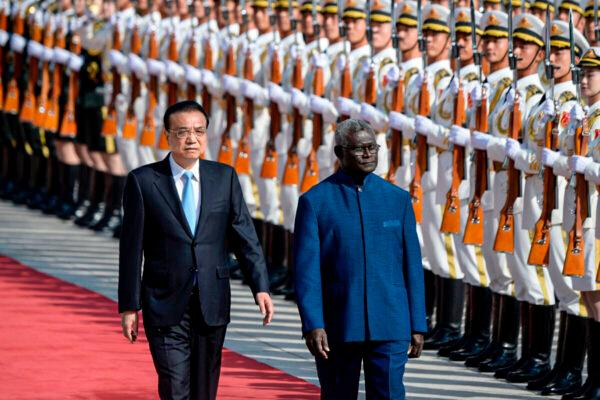 Solomon Islands Prime Minister Manasseh Sogavare (R) and Chinese Premier Li Keqiang inspect honour guards during a welcome ceremony at the Great Hall of the People in Beijing on Oct. 9, 2019. (Wang Zhao/AFP via Getty Images)