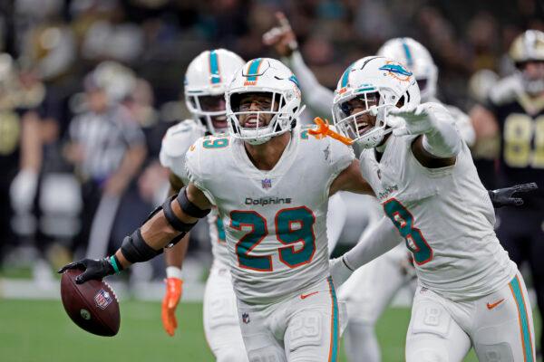 Miami Dolphins safety Brandon Jones (29) celebrates with Jevon Holland (8) after intercepting a pass against the New Orleans Saints during the second half of an NFL football game in New Orleans, on Dec. 27, 2021. (Butch Dill/AP Photo)