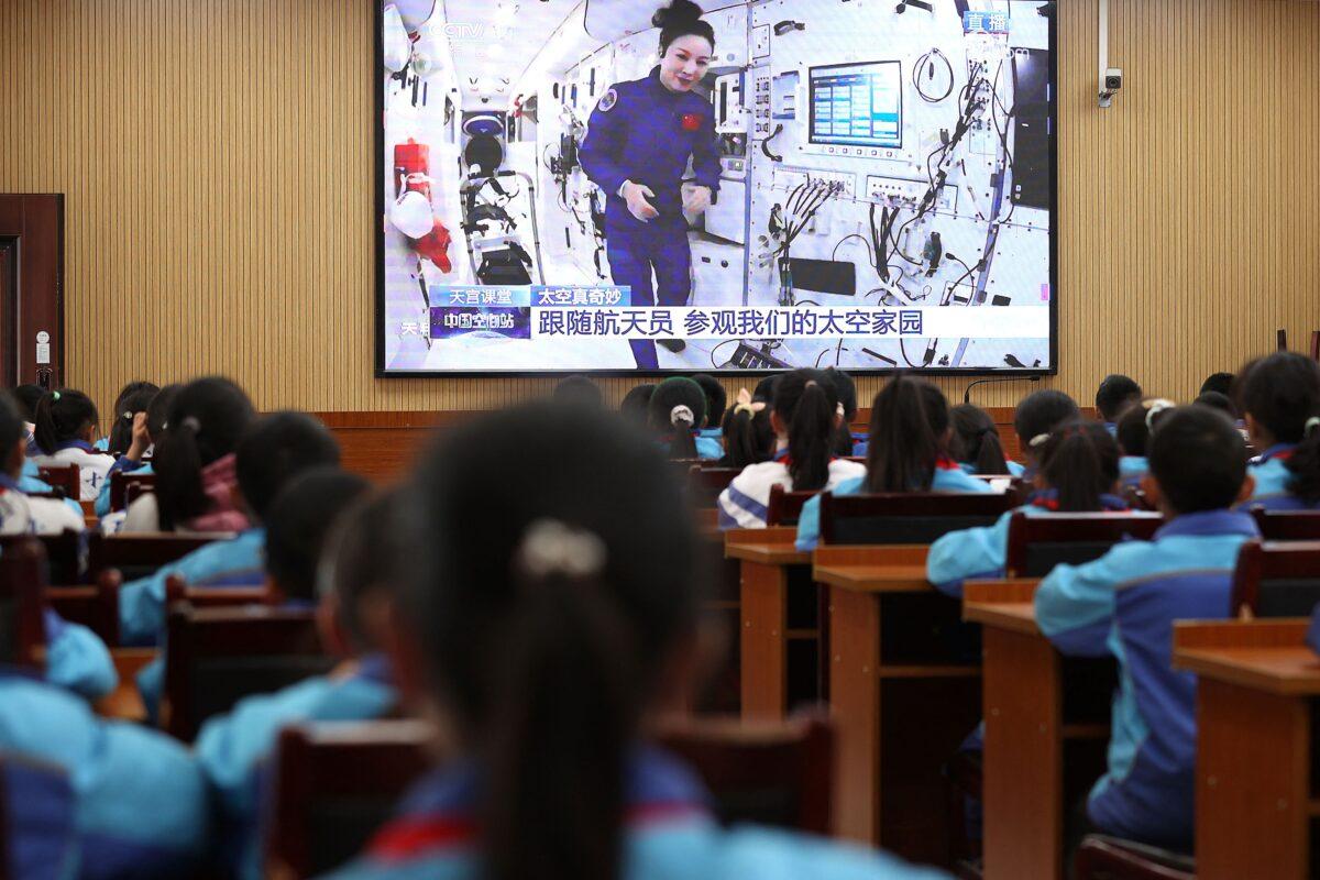 Students watch a lesson by Chinese astronauts from China's Tiangong space station, at a school in Danzhai, Guizhou Province, China, as the regime’s patriotism education on Dec. 9, 2021. (STR/AFP via Getty Images)