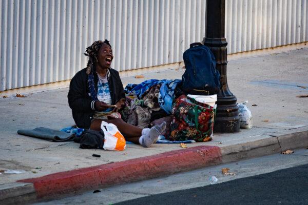A homeless individual sits on the streets of Santa Ana on Sept. 4, 2020. (John Fredricks/The Epoch Times)