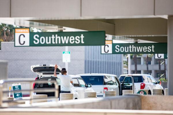Travelers arrive at John Wayne Airport, in Santa Ana, Calif., on Dec. 30, 2020. (John Fredricks/The Epoch Times)