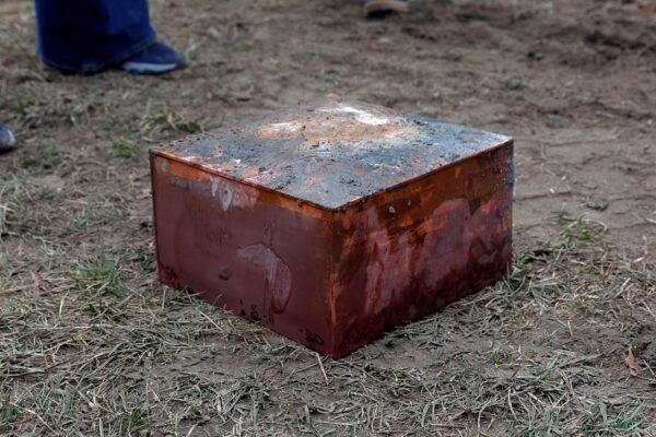 Workers recover a box believed to be the 1887 time capsule that was put under Confederate Gen. Robert E. Lee's statue pedestal in Richmond, Va., on Dec. 27, 2021. (Eva Russo/Richmond Times-Dispatch via AP)