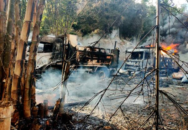 In this photo, provided by the Karenni Nationalities Defense Force (KNDF), smoke and flames billow from vehicles in Hpruso township, Kayah state, Myanmar, on Dec. 24, 2021. (KNDF via AP)
