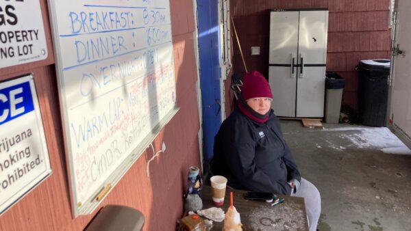 Kaety West sits outside the warming center set up at the West Seattle American Legion Hall Post 160, in Seattle, on Dec. 27, 2021. (Manuel Valdes/AP Photo)