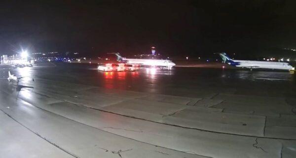 A plane drops off immigrant children at Scranton International Airport on Christmas night, Dec. 25. 2021 while three buses stand ready for the next leg of their journey. (Courtesy Jim Gallagher, Aviation Technologies)