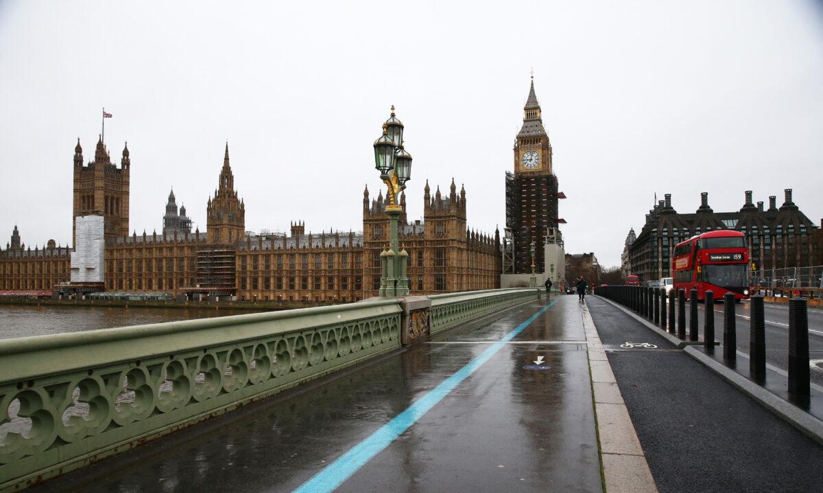 A bus goes past the Houses of Parliament and the Big Ben in London on Dec. 29, 2021. (Hollie Adams/AFP via Getty Images)