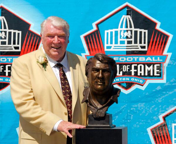 Broadcaster and former Oakland Raiders coach John Madden poses with his bust after enshrinement into the Pro Football Hall of Fame, in Canton, Ohio, on Aug. 5, 2006. (Mark Duncan/AP Photo)