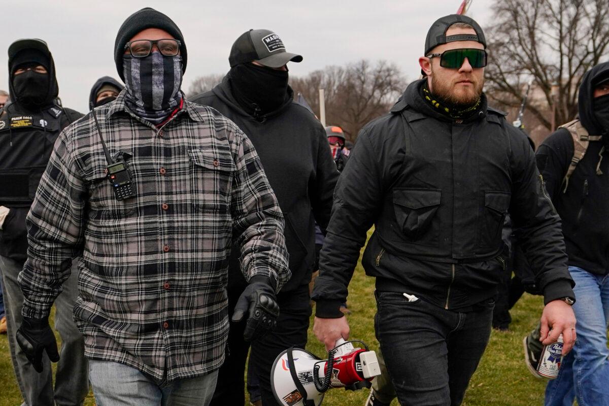 Proud Boys members Joseph Biggs, left, and Ethan Nordean, right with megaphone, walk toward the U.S. Capitol, on Jan. 6, 2021. (Carolyn Kaster/AP Photo)