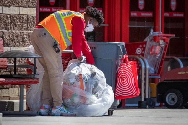 A Target worker cleans up trash in Costa Mesa, Calif. on March 1, 2021. (John Fredricks/The Epoch Times)
