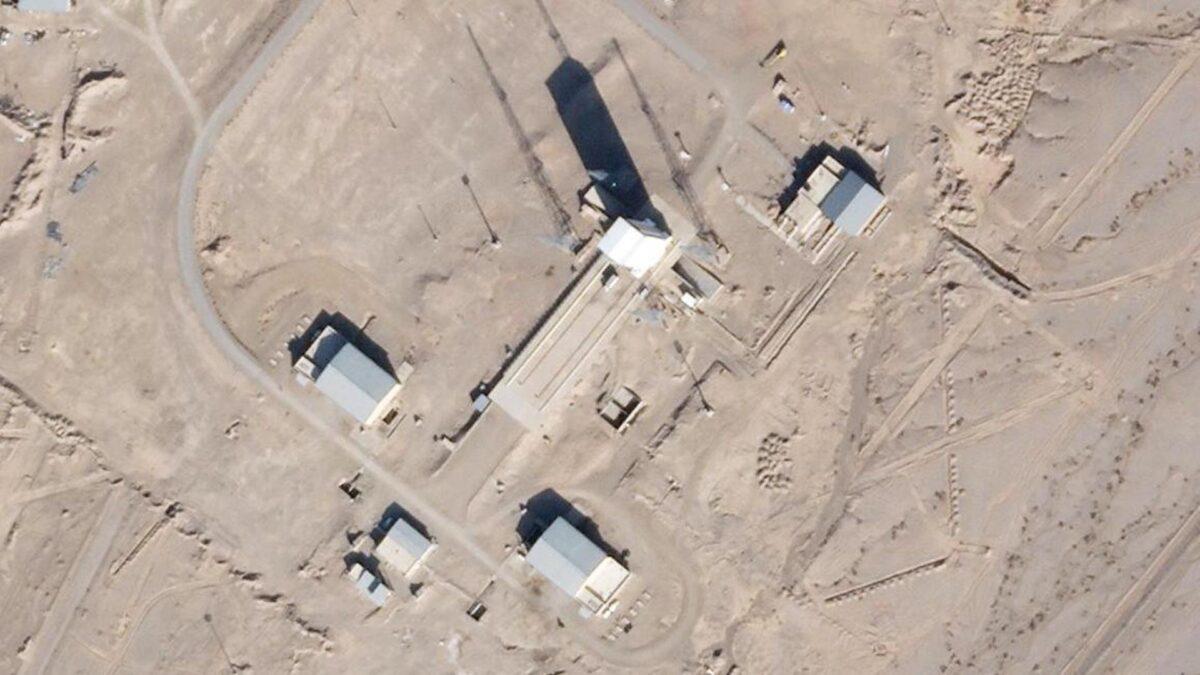In this satellite photo by Planet Labs Inc., a support vehicle stands parked alongside a massive white gantry that typically houses a rocket on the launch pad as activity is seen at the Imam Khomeini Spaceport in Semnan province, Iran, on Dec. 11, 2021. (Planet Labs Inc. via AP)