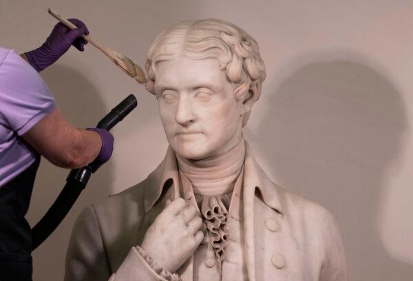 A worker cleans a statue of President Thomas Jefferson inside the Capitol in Washington on Aug. 4, 2021. (Kevin Dietsch/Getty Images)