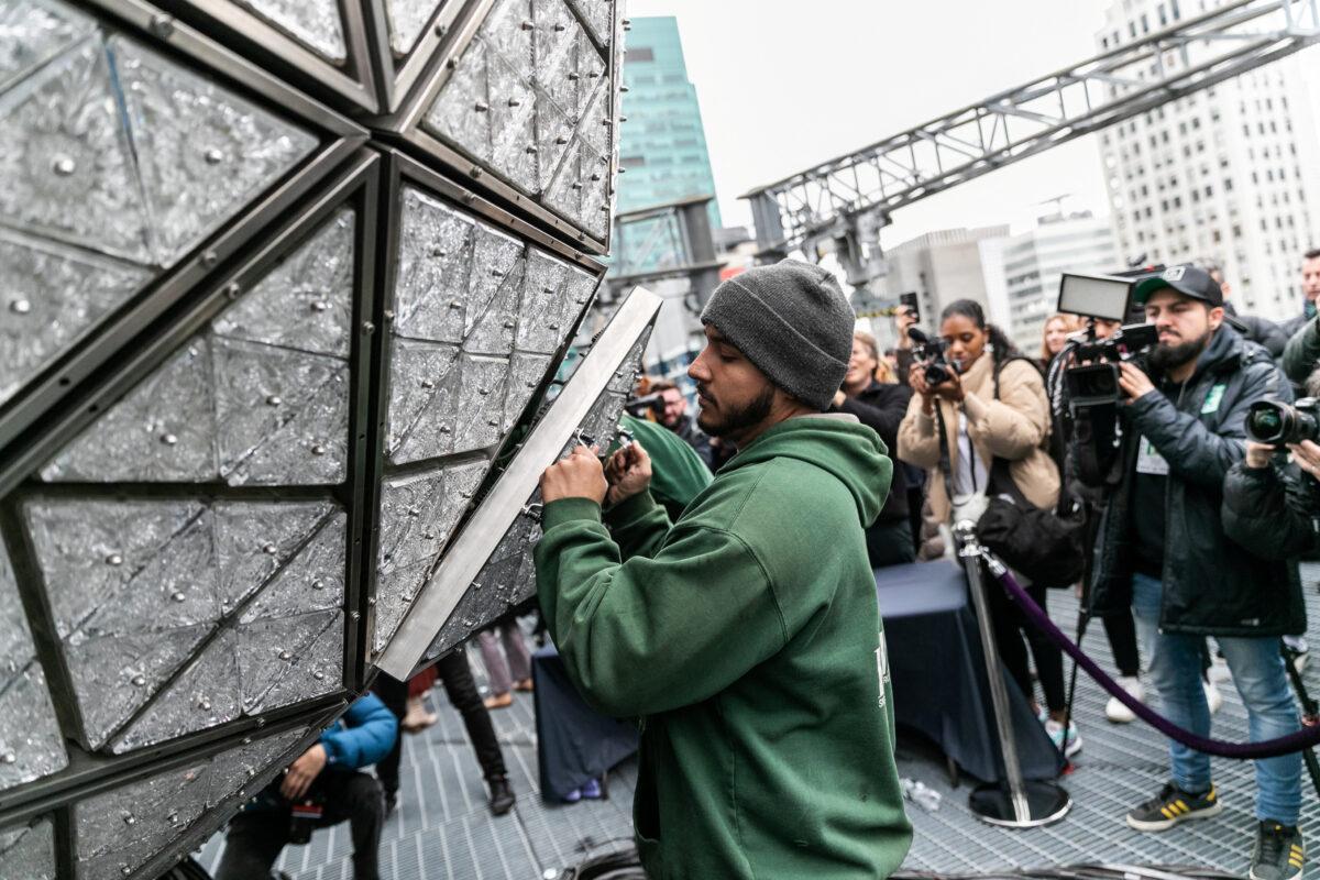 Workers install Waterford Crystal triangles on the Times Square New Year's Eve Ball on the roof of One Times Square in Manhattan, N.Y., in a file photograph. (Jeenah Moon/Reuters)
