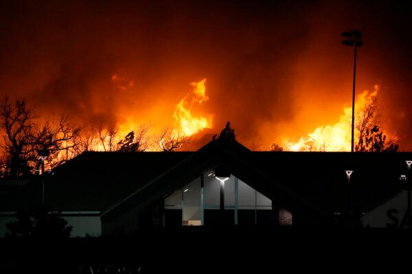 Flames explode as wildfires burned near a small shopping center near Broomfield, Colo., on Dec. 30, 2021. (AP Photo/David Zalubowski)