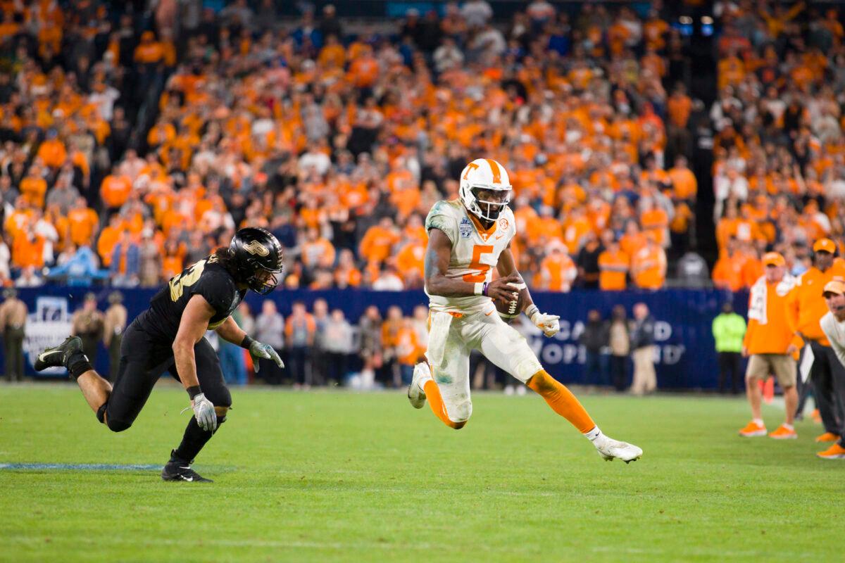 Hendon Hooker #5 of the Tennessee Volunteers runs with the ball to convert on fourth down against the Purdue Boilermakers during overtime of the TransPerfect Music City Bowl at Nissan Stadium, in Nashville, on Dec. 30, 2021. (Brett Carlsen/Getty Images)