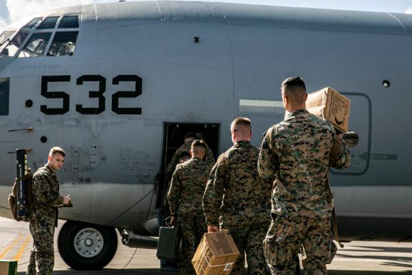 U.S. Marines and Sailors with Combat Logistics Regiment 3, 3rd Marine Logistics Group, board a U.S. Air Force C-130 Hercules at Kadena Air Base, Japan, on Dec. 6, 2021. (U.S. Marine Corps photo by Sgt. Hailey D. Clay)