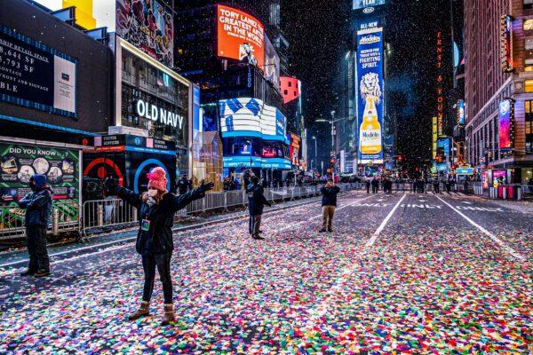 Jaclyn Bernstein of New York stands in confetti, among the few to observe the Times Square New Year's Eve ball drop in New York on Jan. 1, 2021. (Craig Ruttle/AP Photo)