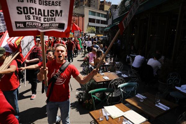 Dozens of people march in May Day protests on May 1, 2018, in New York City. Across the country and world people are protesting, marching, and staying home from work on the traditional day of worker's rights. (Spencer Platt/Getty Images)