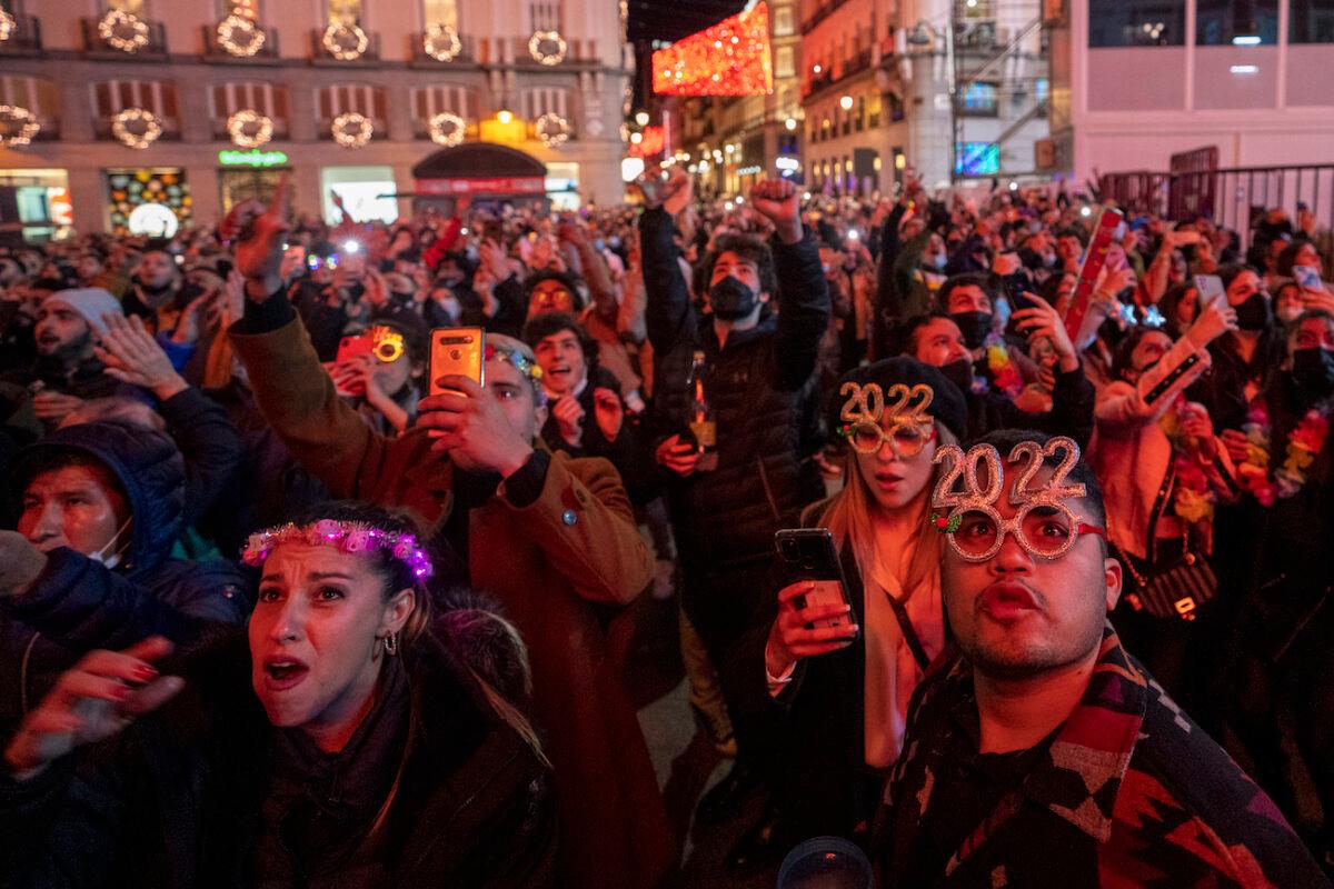 People celebrate during New Year's celebrations at Madrid's Puerta del Sol in downtown Madrid, Spain, on Jan. 1, 2022. (Manu Fernandez/AP Photo)