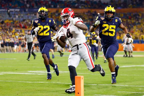 James Cook #4 of the Georgia Bulldogs runs the ball into the end zone for a touchdown in the fourth quarter of the game against the Michigan Wolverines in the Capital One Orange Bowl for the College Football Playoff semifinal game at Hard Rock Stadium, in Miami Gardens, Fla., on Dec. 31, 2021. (Michael Reaves/Getty Images)