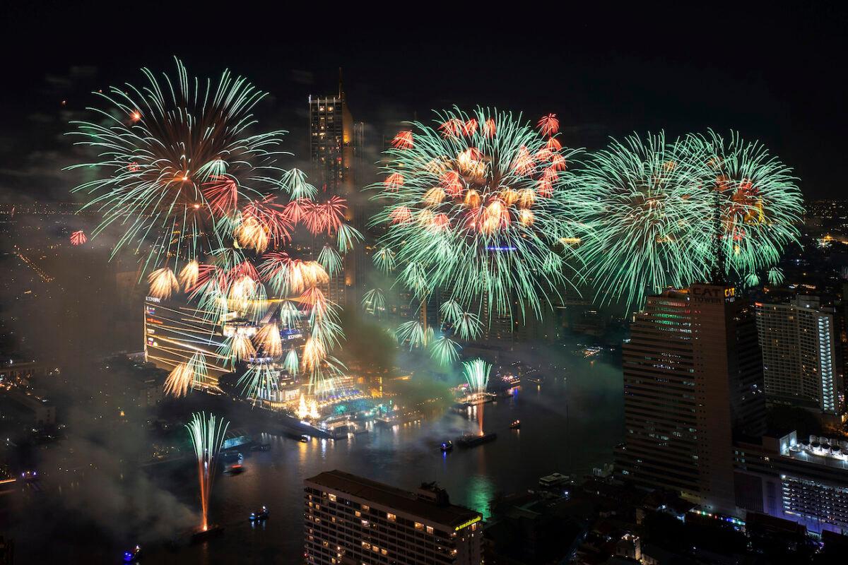 Fireworks explode over the Chao Phraya River during New Year celebrations in Bangkok, Thailand, Jan. 1, 2022, (Wason Wanichakorn/AP Photo)