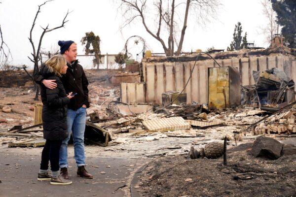 Christian Harrison and Deb Harrison react to the damage of their home in The Enclave after the wildfire in Louisville, Colo., on Dec. 31, 2021. (Michael Madrid/USA Today Network via Reuters)