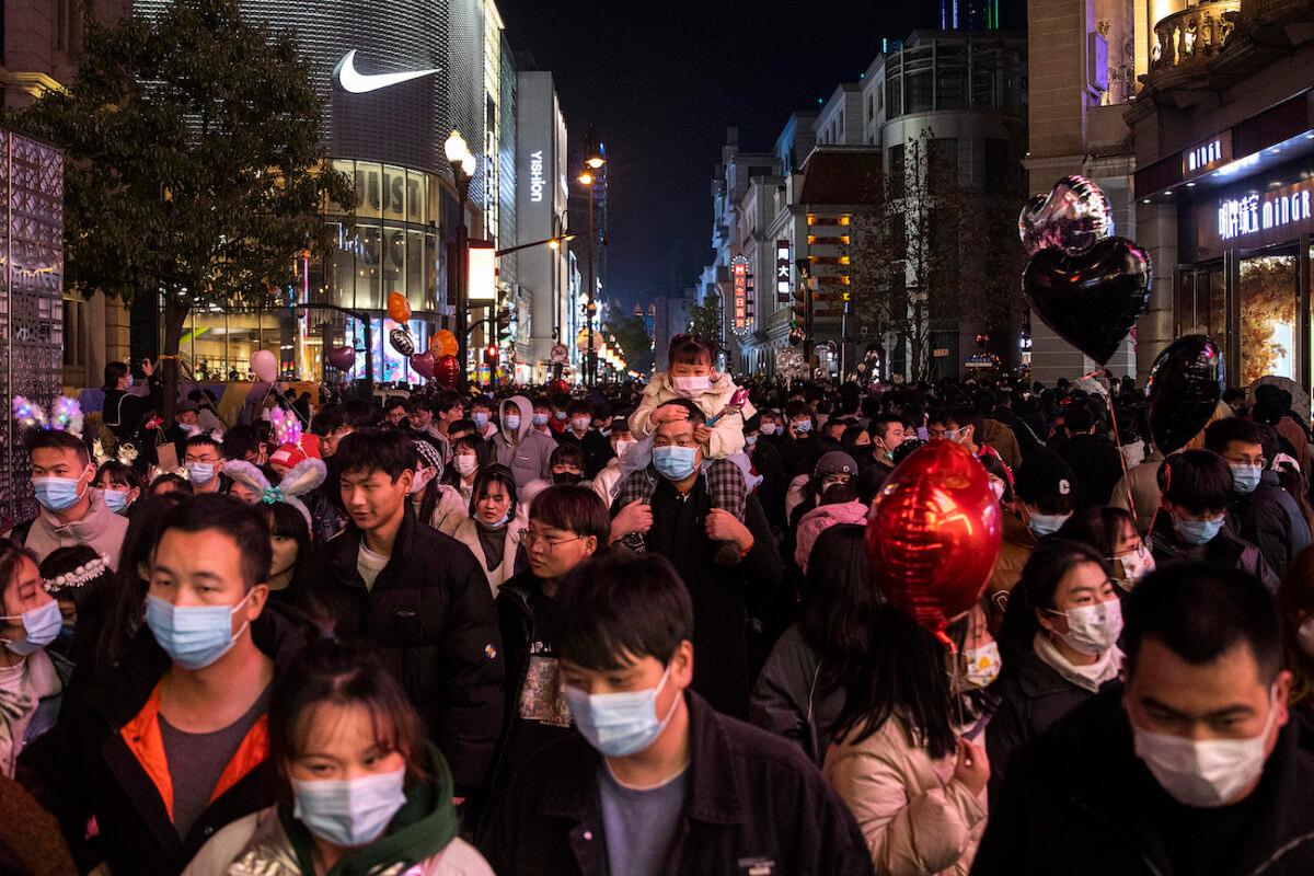 People walk in the street to celebrate the new year in Wuhan, Hubei Province, China, on Dec. 31, 2021. (Getty Images)