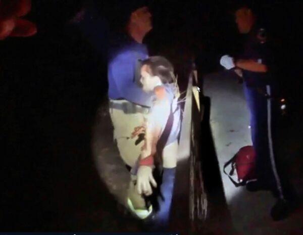 This photo from police body camera footage shows police assisting a man after a Malayan tiger grabbed his arm at the Naples Zoo in Naples, Fla. (Collier County Sheriff's Office via AP)