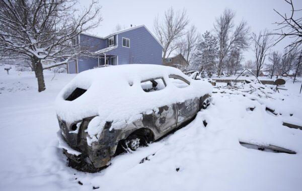 The remains of a home destroyed by a pair of wildfires is draped by nearly a foot of snow in Superior, Colo., on Jan. 1, 2022. (David Zalubowski/AP Photo)