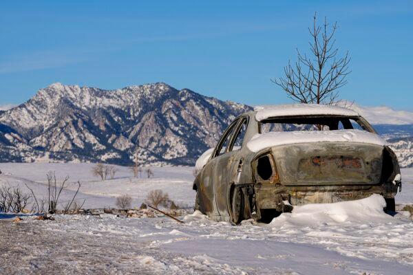 Snow covers the burned remains of a car after wildfires ravaged the area, in Superior, Colo., on Jan. 2, 2022. (Jack Dempsey/AP Photo)