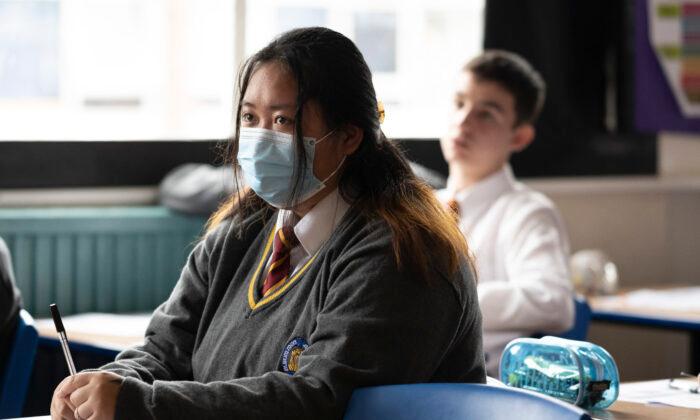 A child wearing a mask listens during a geography lesson at Whitchurch High School in Cardiff, Wales, on Sept. 14, 2021. (Matthew Horwood/Getty Images)