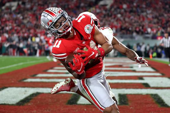 Jaxon Smith-Njigba #11 of the Ohio State Buckeyes catches a touchdown pass as Malone Mataele #15 of the Utah Utes defends during the fourth quarter in the Rose Bowl Game at Rose Bowl, in Pasadena, Calif., on Jan. 1, 2022. (Sean M. Haffey/Getty Images)