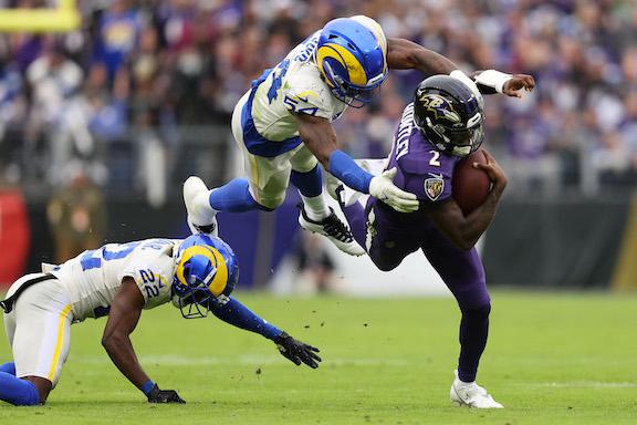 Tyler Huntley #2 of the Baltimore Ravens runs with the ball as Leonard Floyd #54 of the Los Angeles Rams tackles in the third quarter at M&T Bank Stadium, in Baltimore, on January 2, 2022. (Patrick Smith/Getty Images)