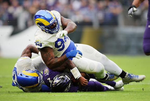 A'Shawn Robinson #94 of the Los Angeles Rams tackles Tyler Huntley #2 of the Baltimore Ravens in the fourth quarter of the game at M&T Bank Stadium, in Baltimore, on January 2, 2022. (Patrick Smith/Getty Images)