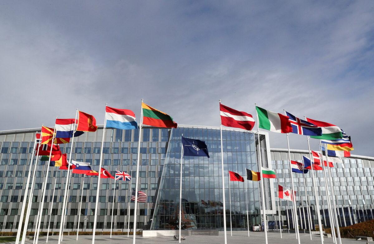 Flags wave outside the Alliance headquarters ahead of a NATO Defence Ministers meeting, in Brussels, Belgium, on Oct. 21, 2021. (Pascal Rossignol/Reuters)