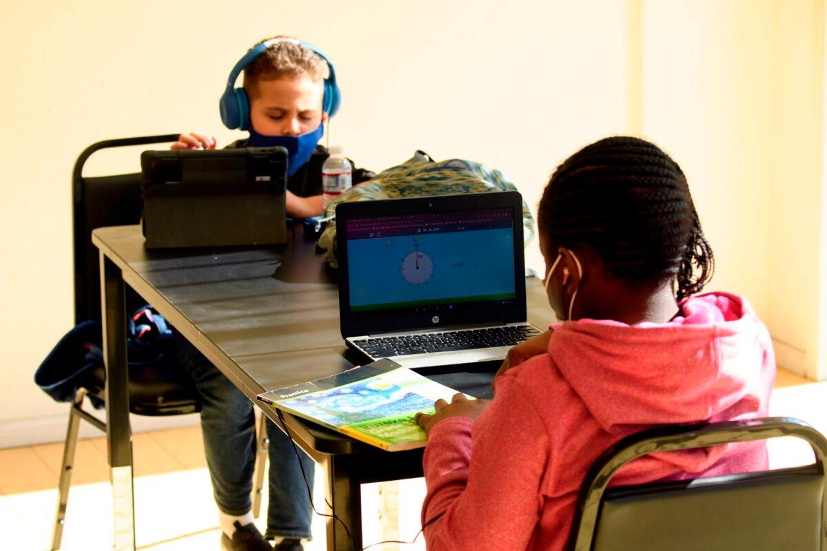 Children attend online classes at a learning hub inside the Crenshaw Family YMCA in Los Angeles on Feb. 17, 2021. (Patrick T. Fallon/AFP via Getty Images)