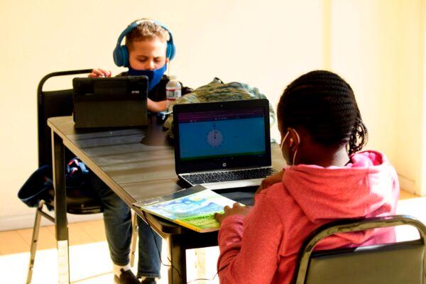 Children attend online classes at a learning hub inside the Crenshaw Family YMCA during the COVID-19 pandemic in Los Angeles, Calif., on Feb. 17, 2021. (PATRICK T. FALLON/AFP via Getty Images)