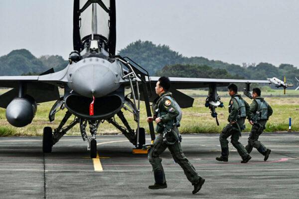 Taiwanese air force pilots run past an armed U.S.-made F-16V fighter jet at an air force base in Chiayi, a city in southern Taiwan, on Jan. 5, 2022. (Sam Yeh/AFP via Getty Images)