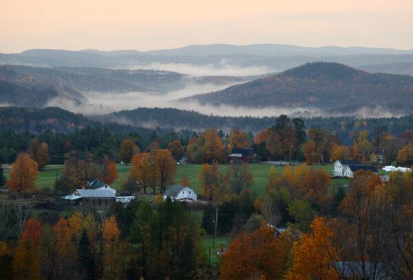 Fog settles between hills at daybreak, seen from the Comstock House bed & breakfast/farm in Plainfield, Vt., on Oct. 20, 2007. (STAN HONDA/AFP via Getty Images)