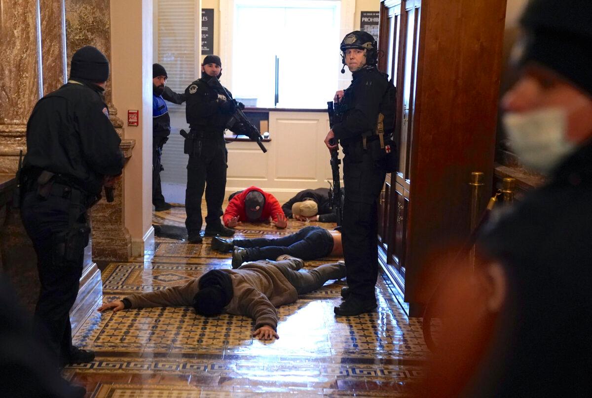 U.S. Capitol Police stand detain protesters outside of the House Chamber during a joint session of Congress on Jan. 06, 2021. (Drew Angerer/Getty Images)