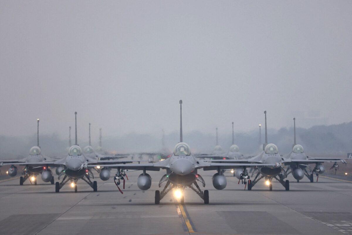 12 F-16V fighter jets perform an elephant walk during an annual New Year’s drill in Chiayi, Taiwan, on Jan. 5, 2022. (Ann Wang/Reuters)