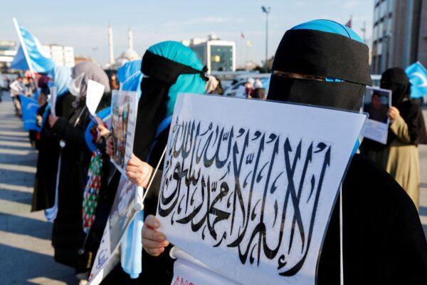 Ethnic Uyghur women take part in a protest against China, in front of the Caglayan Courthouse in Istanbul, Turkey, on Jan. 4, 2022. (Dilara Senkaya/Reuters)