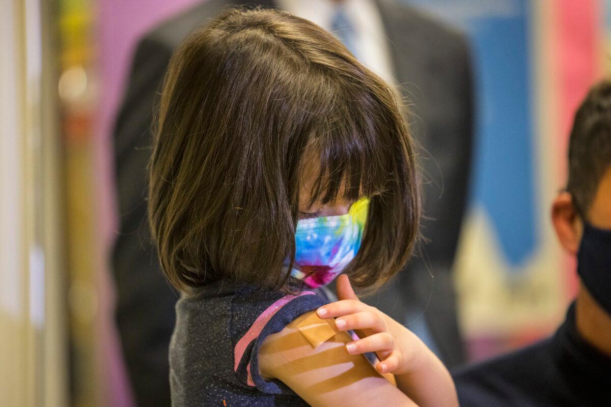 A 5-year-old girl looks at her arm after getting a Pfizer COVID-19 vaccine in New York City on Nov. 8, 2021. (Michael M. Santiago/Getty Images)