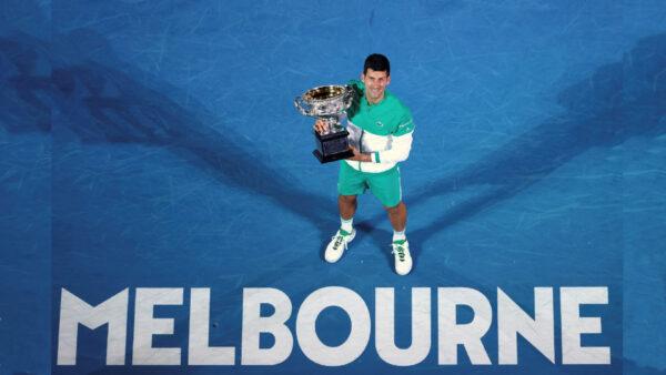 Serbia's Novak Djokovic holds the Norman Brookes Challenge Cup after defeating Russia's Daniil Medvedev in the men's singles final at the Australian Open tennis championship in Melbourne, Australia, on Feb. 21, 2021. (Hamish Blair/AP Photo)