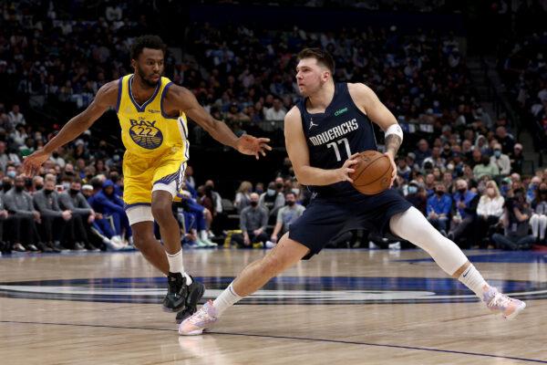 Luka Doncic #77 of the Dallas Mavericks dribbles the ball against Andrew Wiggins #22 of the Golden State Warriors in the first quarter at American Airlines Center, in Dallas, on Jan. 5, 2022. (Tom Pennington/Getty Images)