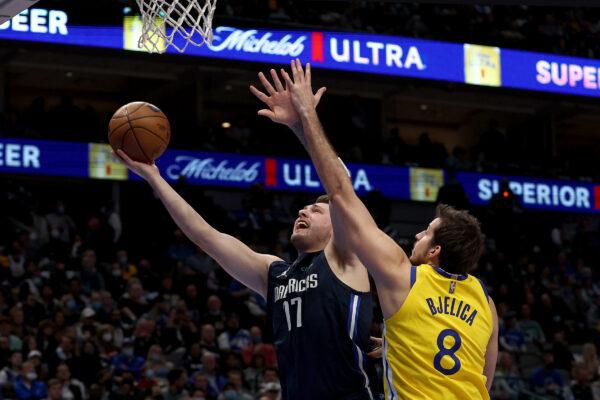 Luka Doncic #77 of the Dallas Mavericks drives to the basket against Nemanja Bjelica #8 of the Golden State Warriors in the first quarter at American Airlines Center, in Dallas, on Jan. 5, 2022. (Tom Pennington/Getty Images)