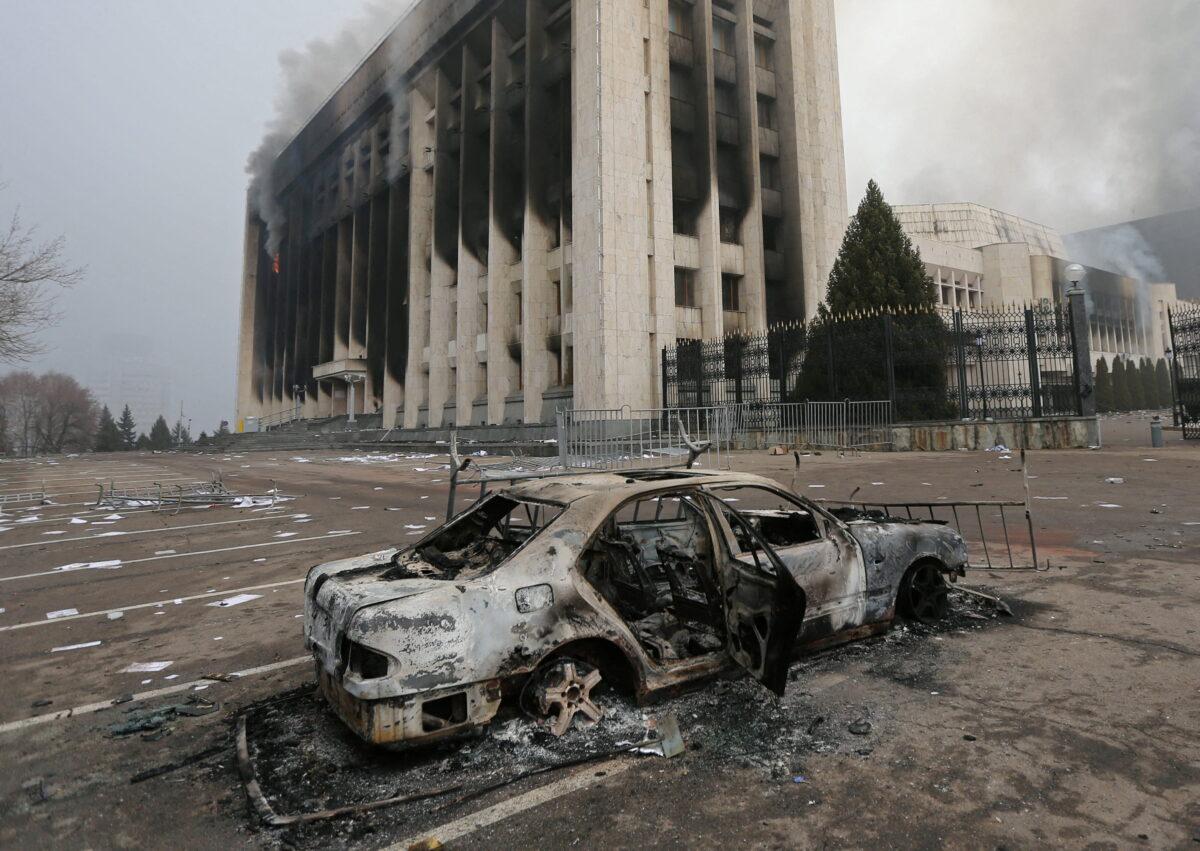 A burned car is seen in front of the mayor's office building which was torched during protests triggered by a fuel price increase in Almaty, Kazakhstan, on Jan. 6, 2022. (Pavel Mikheyev/Reuters)