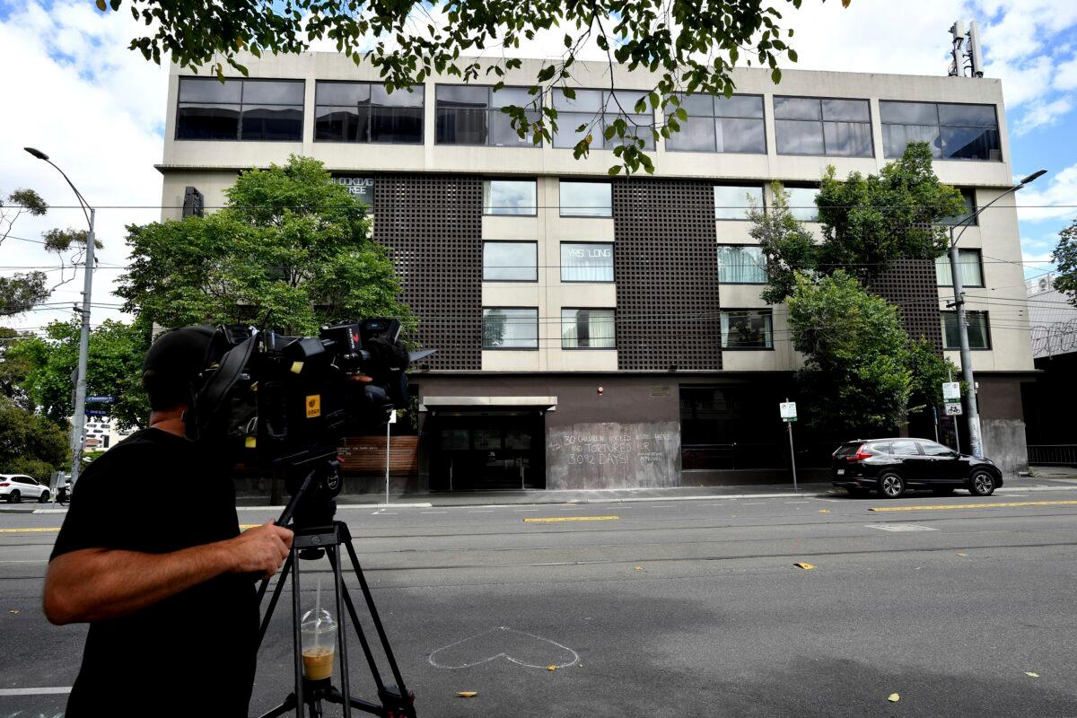 A television cameraman films a hotel, where Serbia's Novak Djokovic is believed to be in, in Melbourne, Australia on Jan. 6, 2022. (Joel Carrett/AAP Image via AP)