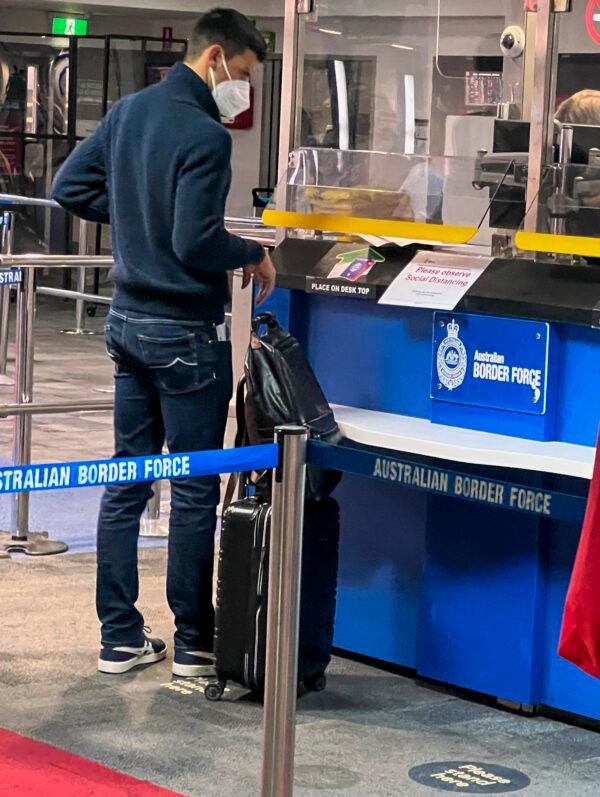 Serbia's Novak Djokovic, the Australian Open defending champion, waits at an Australian Border Force desk on his arrival at Melbourne Airport, Australia, on Jan. 5, 2022. (AP Photo)
